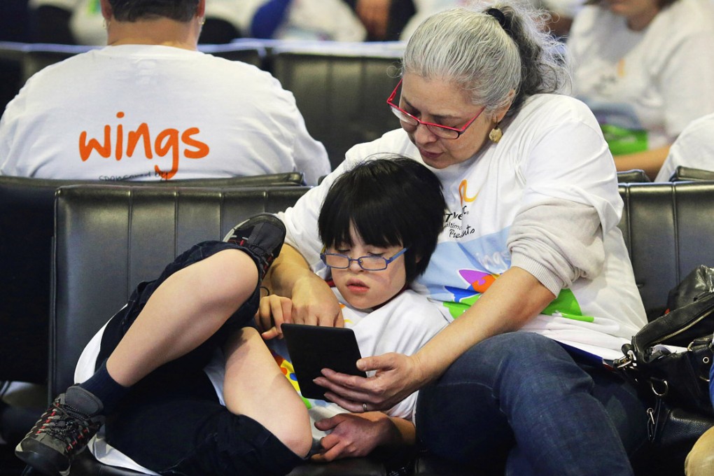 Families took part in a typical airport experience, from check-in and security to boarding a plane, with the intention of alleviating some of the stress of air travel for children with autism. Photo: AP