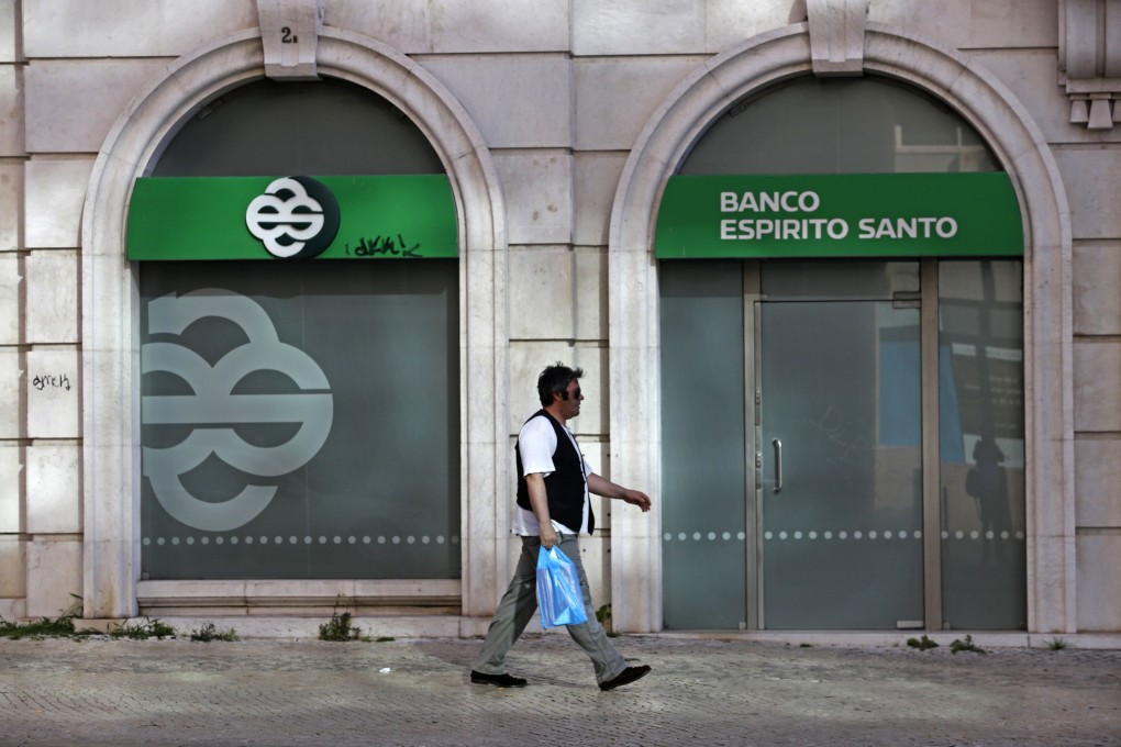 A man walks past an office of Portuguese bank Banco Espirito Santo. Photo: Reuters