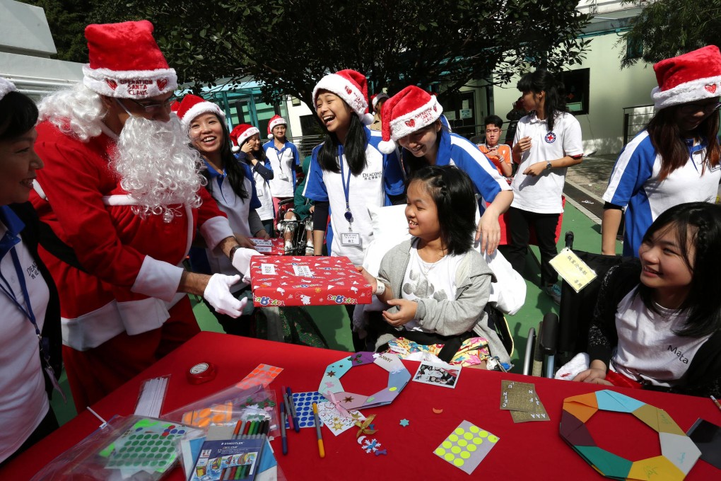 Volunteers from the Deacons law firm join Art in Hospital in bringing smiles to youngsters at the Duchess of Kent Children's Hospital - and a close encounter with Santa Claus. Photos: Jonathan Wong