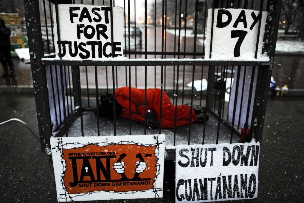 A protester demands the closure of Guantanamo Bay in 2012. Many now want to see prosecutions over interrogation methods. Photo: AFP