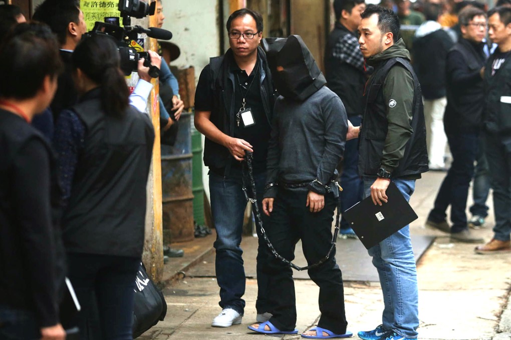 A suspect escort by police back to Mongkok after killing a 15-year-old girls and dumping her body at refuse collection centre. Photo: Sam Tsang