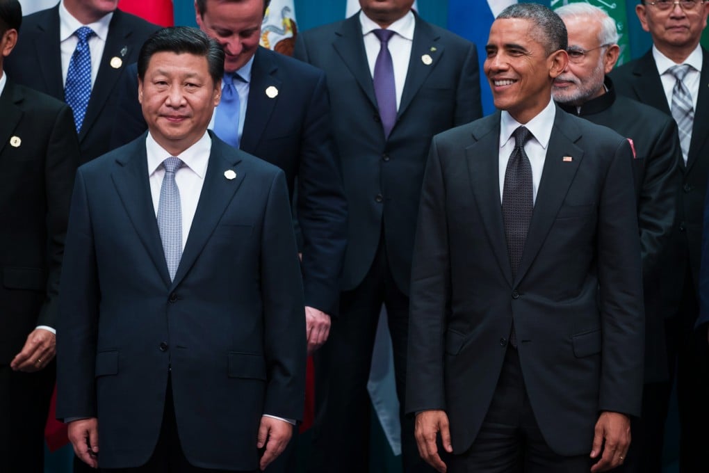 Xi Jinping, China's president, left, and U.S. President Barack Obama stand for a family photograph at the Group of 20 (G-20) summit in Brisbane, Australia, on Saturday, Nov. 15, 2014. Photo: Bloomberg