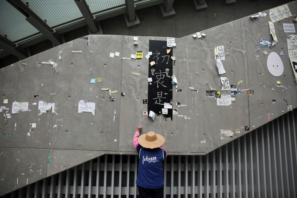 A worker cleans the area of the main pro-democracy protest site in Admiralty yesterday after the police clearance operation. Photo: AFP