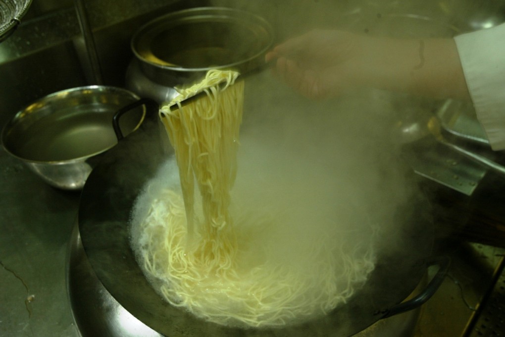Cook uses his noodles to entertain patrons.