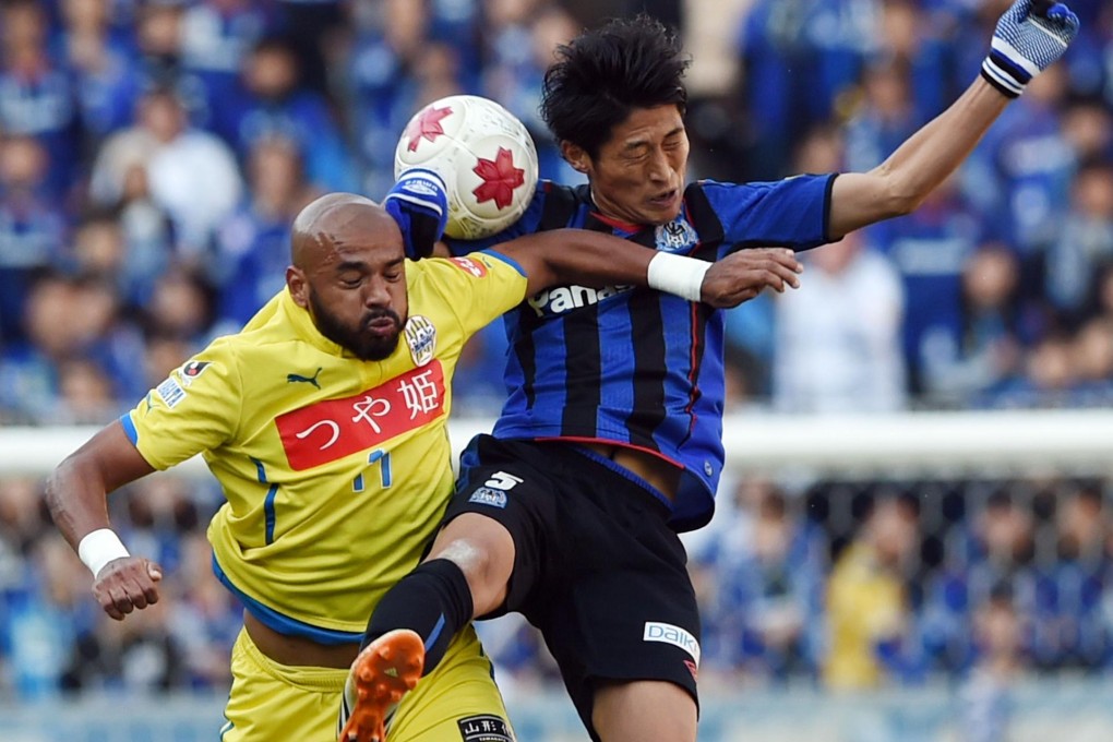 Yamagata's Diego and Gamba's Daiki Niwa fight for the ball during the Cup final.Photo: AFP