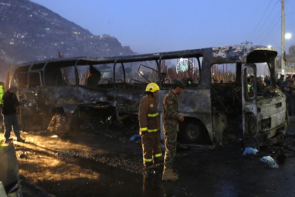 Afghan security forces inspect the site of a suicide attack on a military bus in Kabul on Saturday. Photo: Reuters