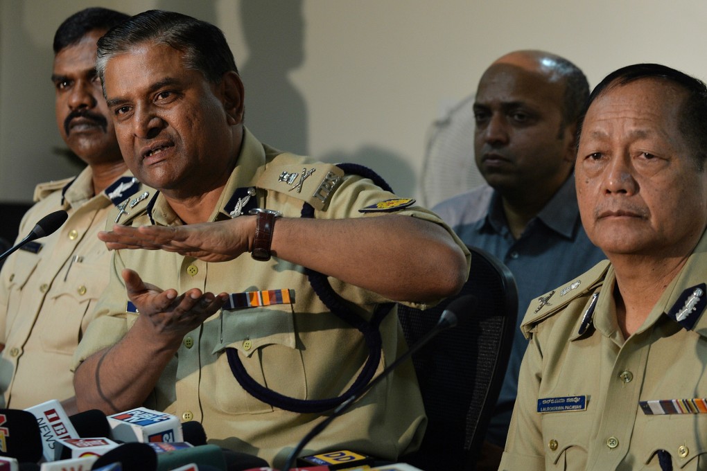 Commissioner of Police MN Reddy gestures whilst speaking as Director General of Police, LR Pachau (right) looks on during a press conference on the arrest in Bangalore on Saturday. photo: AFP