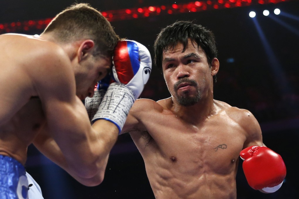 WBO welterweight champion Manny Pacquiao punches Chris Algieri at the CotaiAerna in the Venetian Macao. Photo: AP