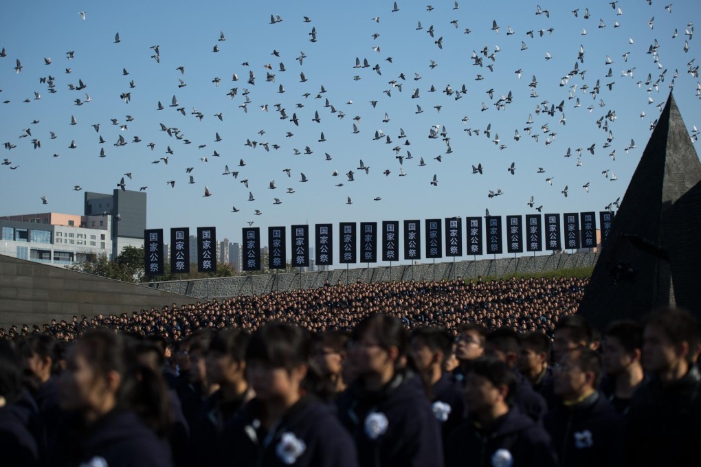Pigeons are let loose during a ceremony at the massacre memorial hall in Nanjing in Jiangsu province. Photo: AFP