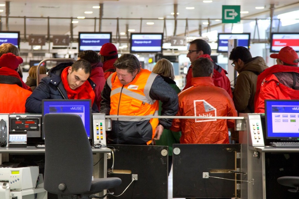 Union workers block a check-in counter at Zaventem airport in Brussels. Photo: AP