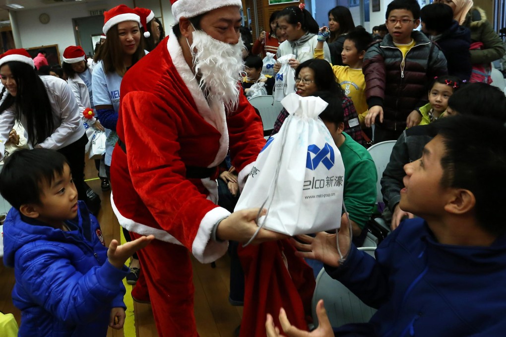 Santa meets pupils from Red Cross Margaret Trench School at a Christmas party that was made extra special thanks to the support of Melco Group. Photo: Jonathan Wong