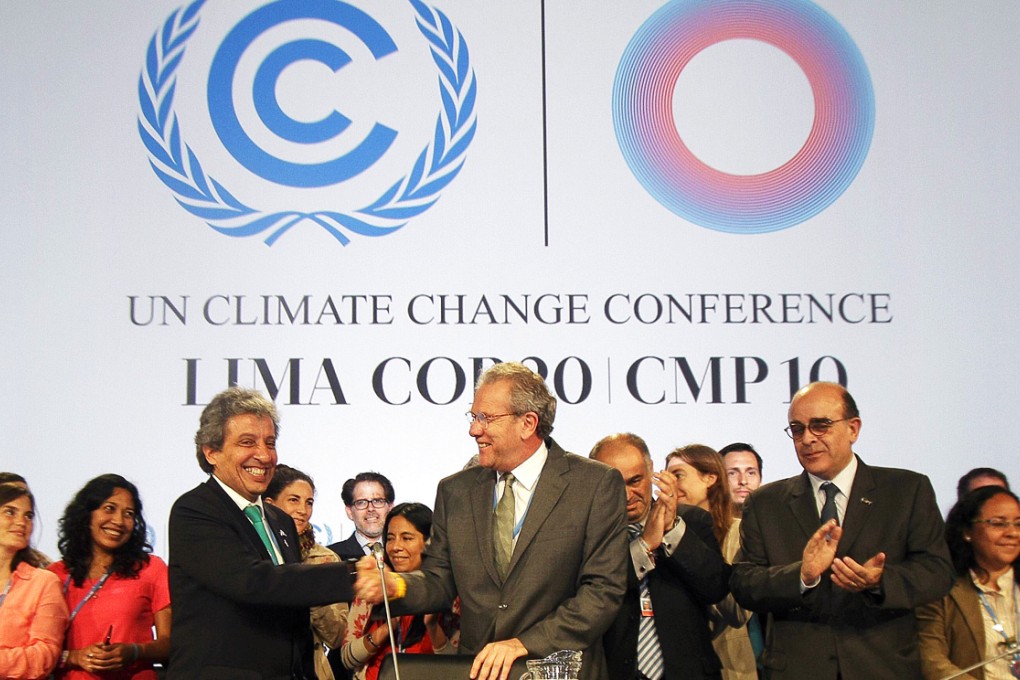 Officials shake hands after 'The Lima Call for Climate Action' was approved. Photo: EPA