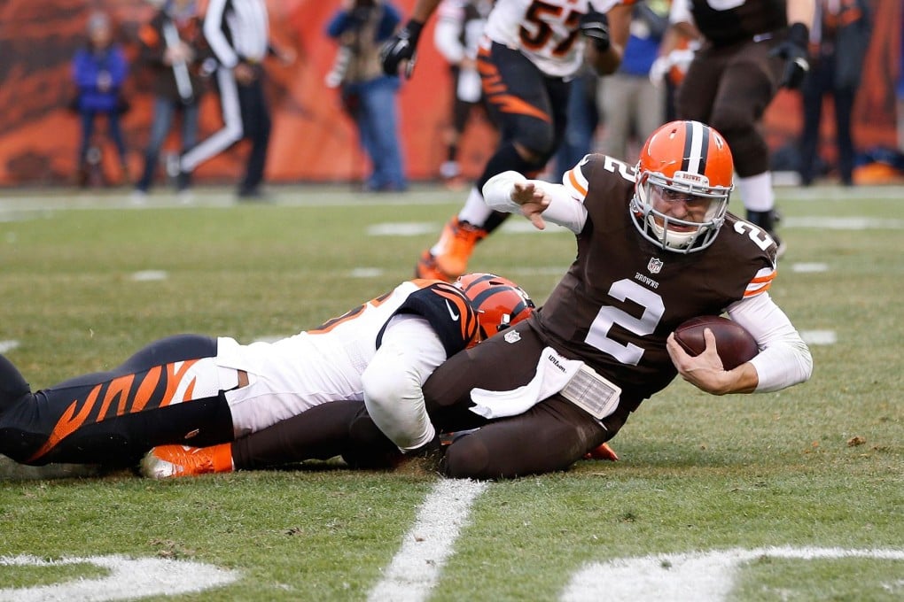 Cleveland's rookie quarterback Johnny Manziel is taken down by Cincinnati Bengals' Chris Carter during their NFL game. Photo: AFP