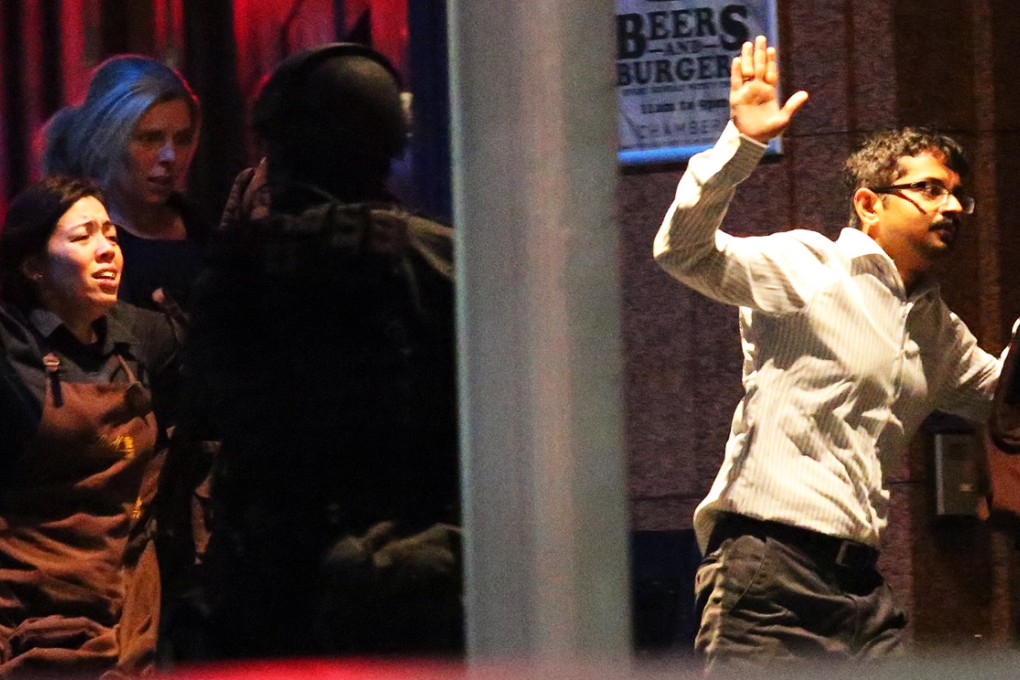 Gunfire and explosions were heard as armed police stormed the Lindt cafe building in Sydney. Photo: AP