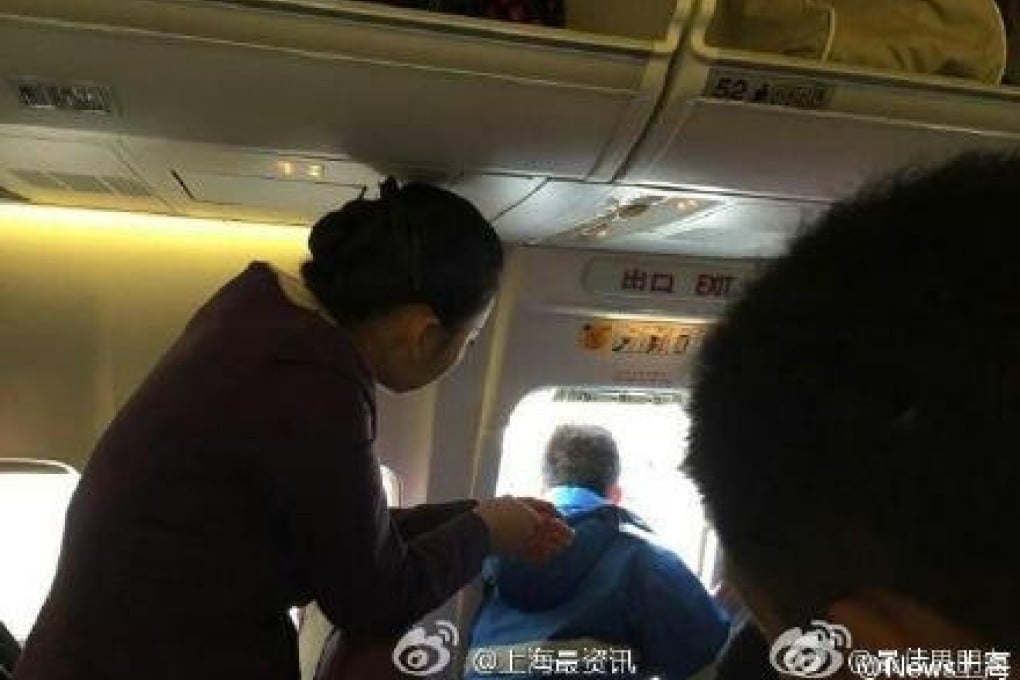 The first-time traveller opened the plane's emergency exit door to get some fresh air. Photo: SCMP Pictures