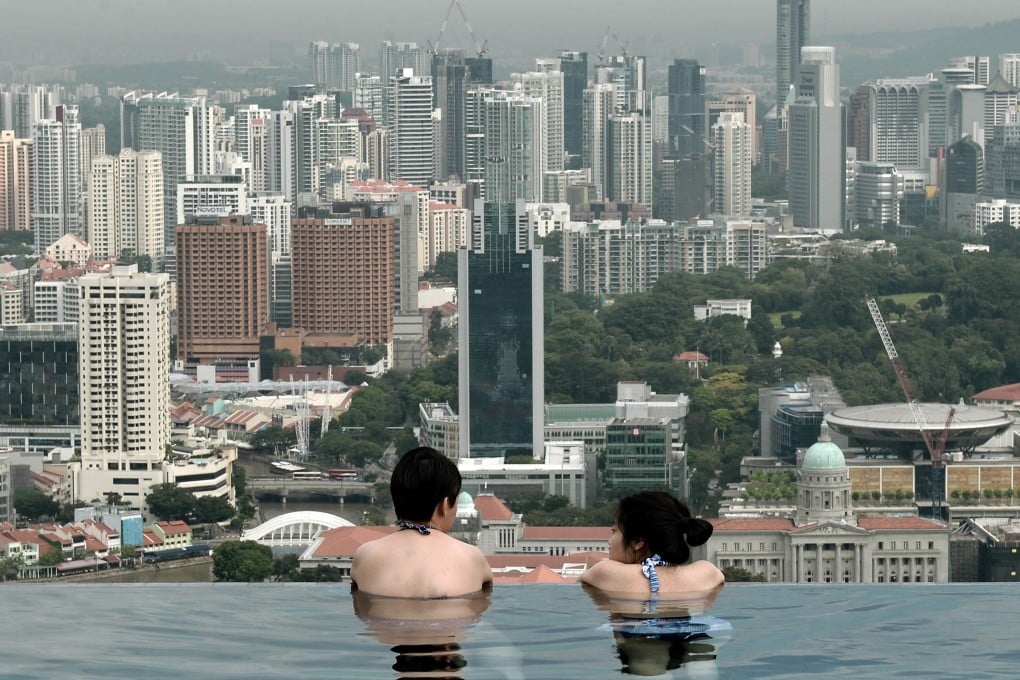 The Singapore government began to introduce residential property curbs in 2009 with some of the strictest measures implemented in 2013, including a cap on debt at 60 per cent of a borrower's income, higher stamp duties on home purchases and an increase in real estate taxes. Photo: AFP