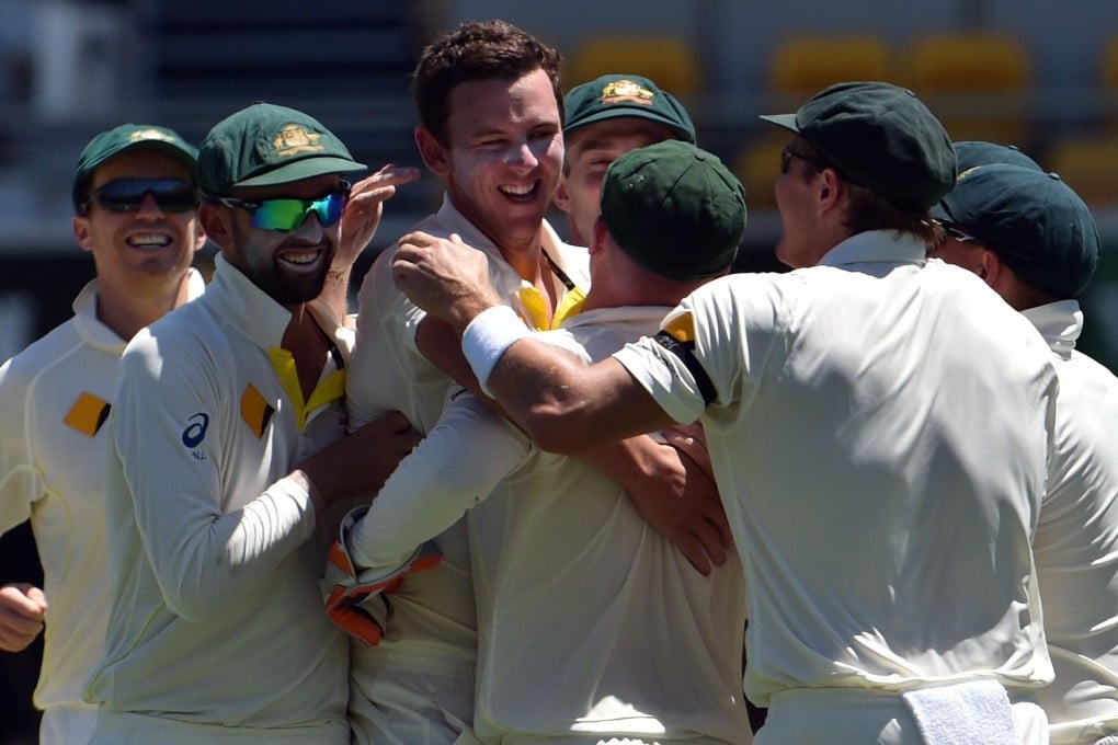 Australia's Josh Hazlewood celebrates the wicket of India's Cheteshwar Pujara with teammates on day one of the second test at the Gabba in Brisbane. Photo: AFP