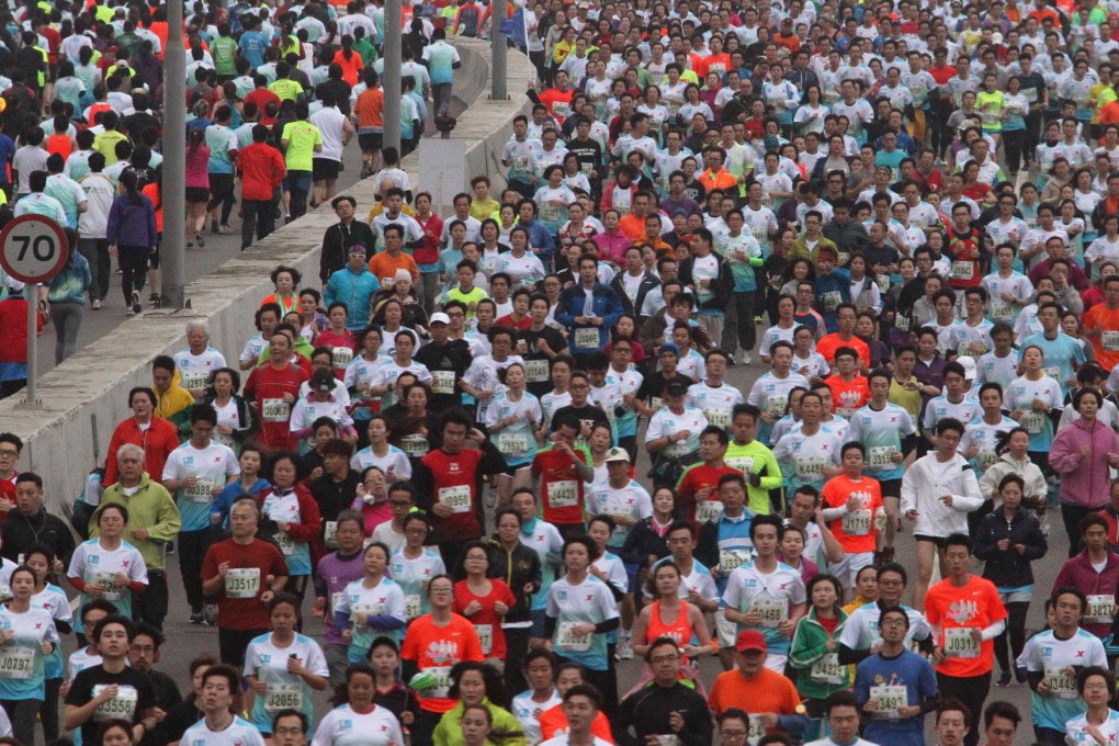 Maximum capacity: Thousands of runners head along the Eastern Corridor expressway during the 10km race as part of the Hong Kong Marathon. Photo: Felix Wong