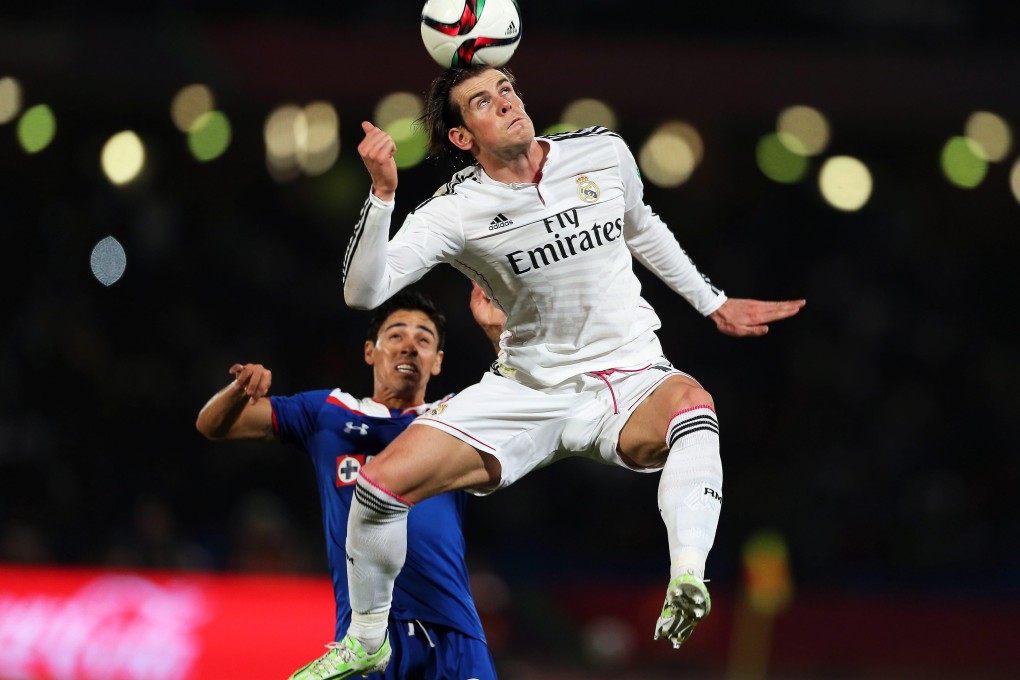 Real Madrid's Gareth Bale beats Cruz Azul's Fausto Pinto to the ball in their Club World Cup semi-final. Photo: EPA