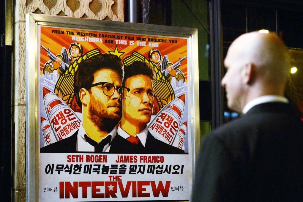 A guard, among a team sent to beef up security, stands outside the cinema during the premiere of the film "The Interview" in Los Angeles. Photo: Reuters