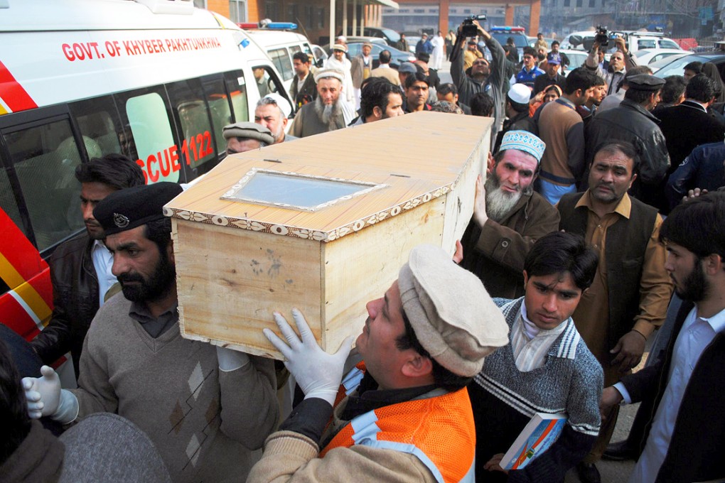 The coffin of a pupil, killed in the school attack by militants, is carried from a hospital in Peshawar. Photo: Xinhua