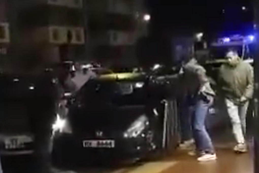 A screen grab from the video shows police confronting the driver of the Honda Jazz.Photo: SCMP Pictures