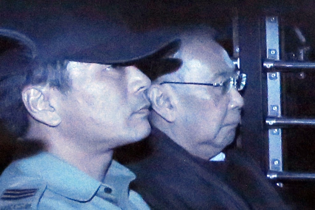 The long trial ends in shame for former chief secretary Rafael Hui (right) as he is taken away in a prison van following the verdict. Photo: AP