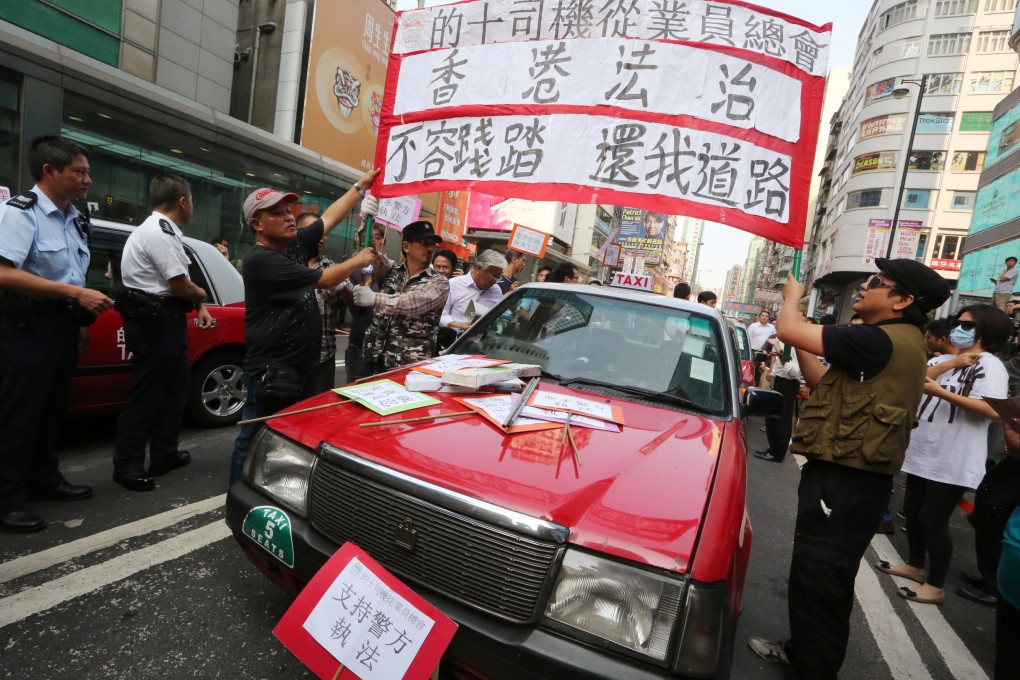Taxi drivers protest against Occupy protesters in Mong Kok on October 22, 2014. Photo: Felix Wong