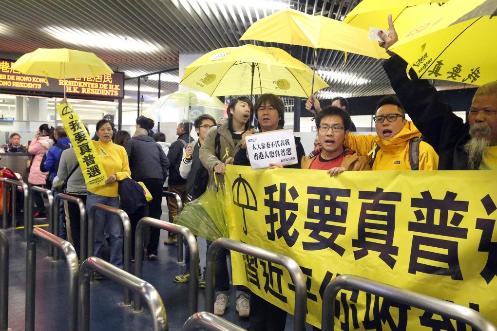A group League of Social Democrats members protest at the ferry terminal before being sent back to Hong Kong. Photo: K.Y. Cheng