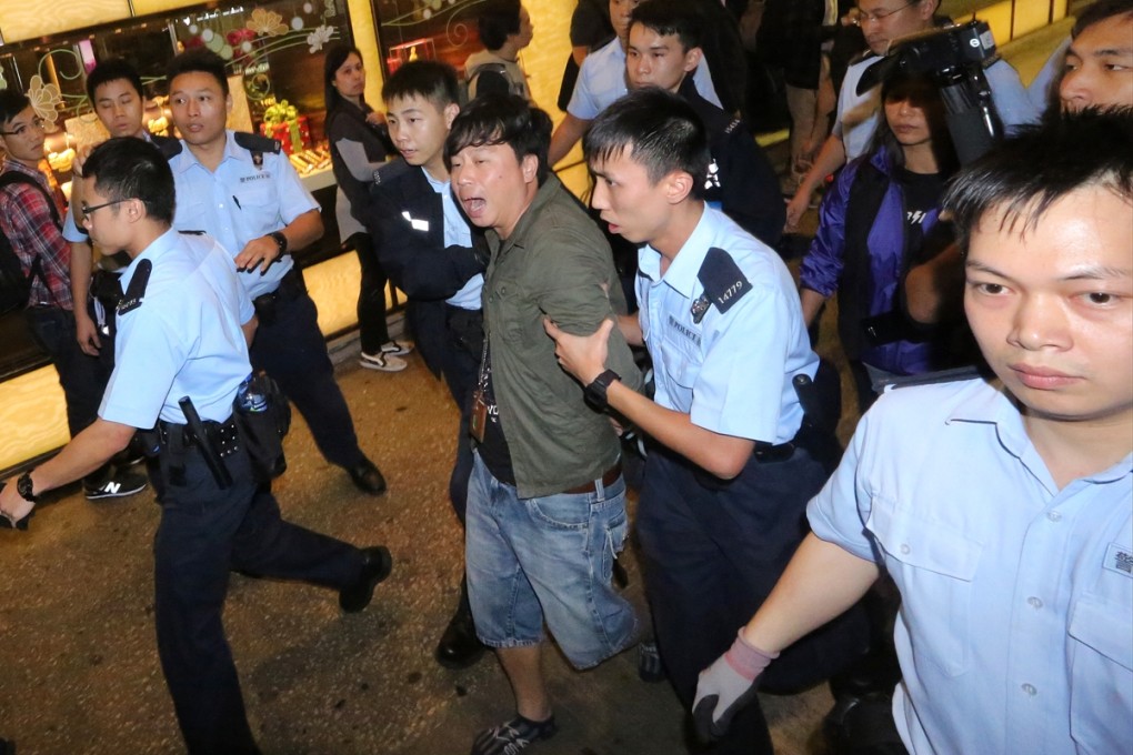 Police officers made an arrest in Mong Kok during the Occupy protest. Photo: Felix Wong