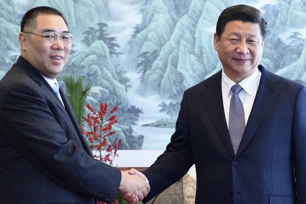 President Xi Jinping (right) greets Macau leader Fernando Chui Sai-on. Photo: AP