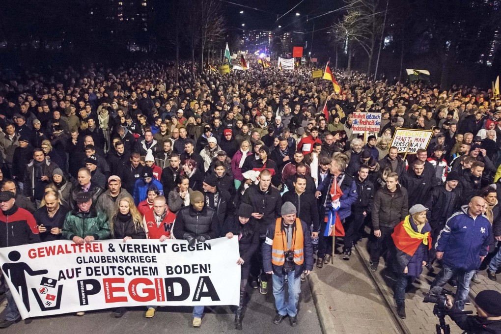 Thousands take part in a rally this month in Dresden, eastern Germany. The banner says: "Non-violent and united against faith wars in Germany".Photo: AP