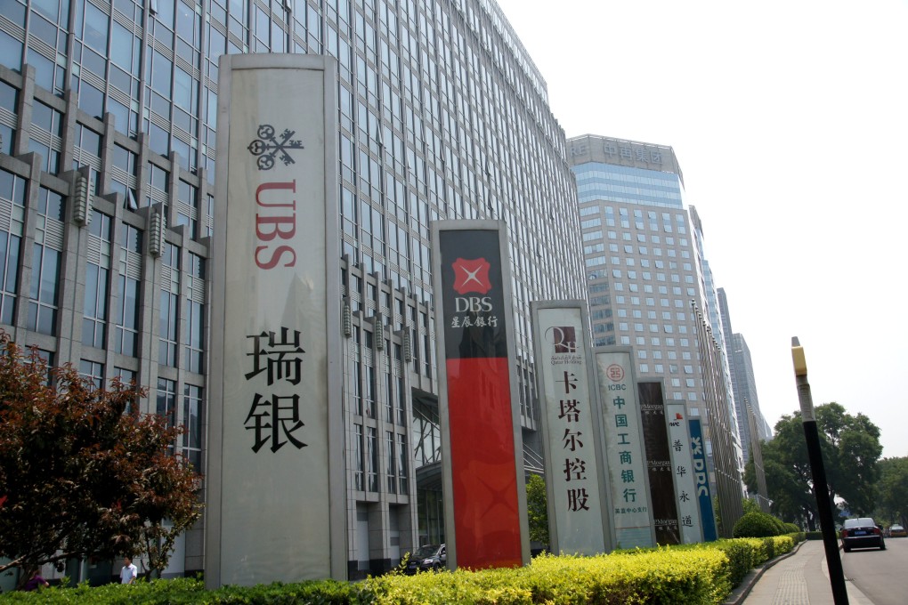 Logos of foreign banks outside an office building in Beijing's financial street. Photo: ImageinChina