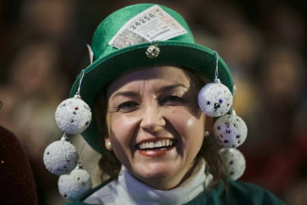 A woman appears full of hope as she attends the Christmas Lottery 'El Gordo' draw at the Royal Theatre in Madrid. Photo: EPA