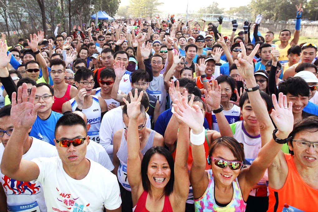 Runners wave as they take part in the recent Brooks 15k Challenge at Sheung Shui. Photo: Dickson Lee