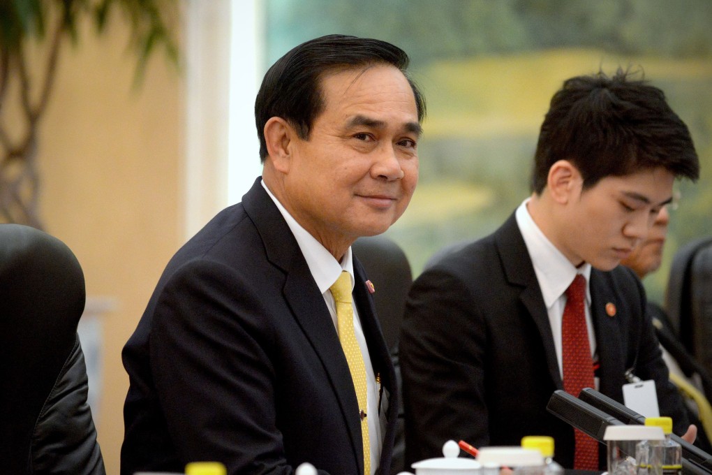 Thailand's Prime Minister Prayuth Chan-ocha, centre, listens as he meets with China's President Xi Jinping (not pictured) at the Great Hall of the People in Beijing December 23, 2014. Photo: Reuters
