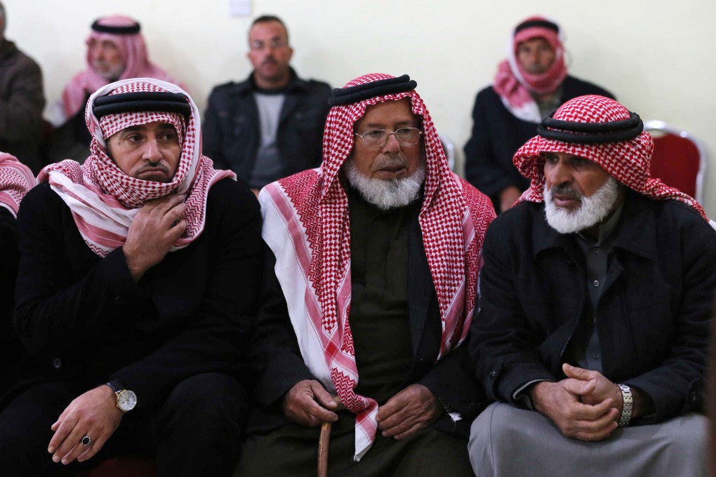 Friends and relatives of Mu'ath Safi al-Kaseasbeh, a Jordanian pilot captured by the Islamic State group, gather in the town of Aey near Al Karak in southern Jordan