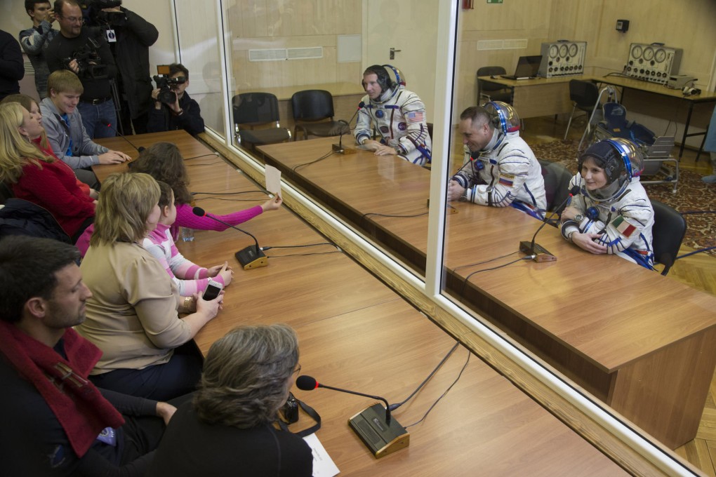 Italian astronaut Samantha Cristoforetti (right) speaks with relatives. Photo: AP
