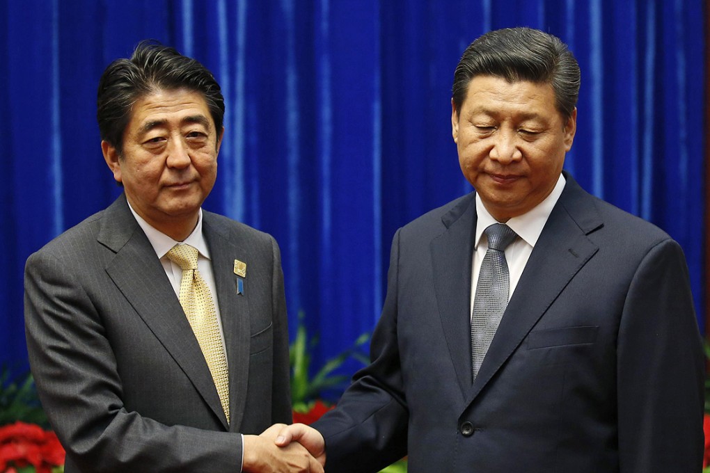 President Xi Jinping (right) shakes hands with Japan's Prime Minister Shinzo Abe during their November meeting in Beijing. Photo: Reuters