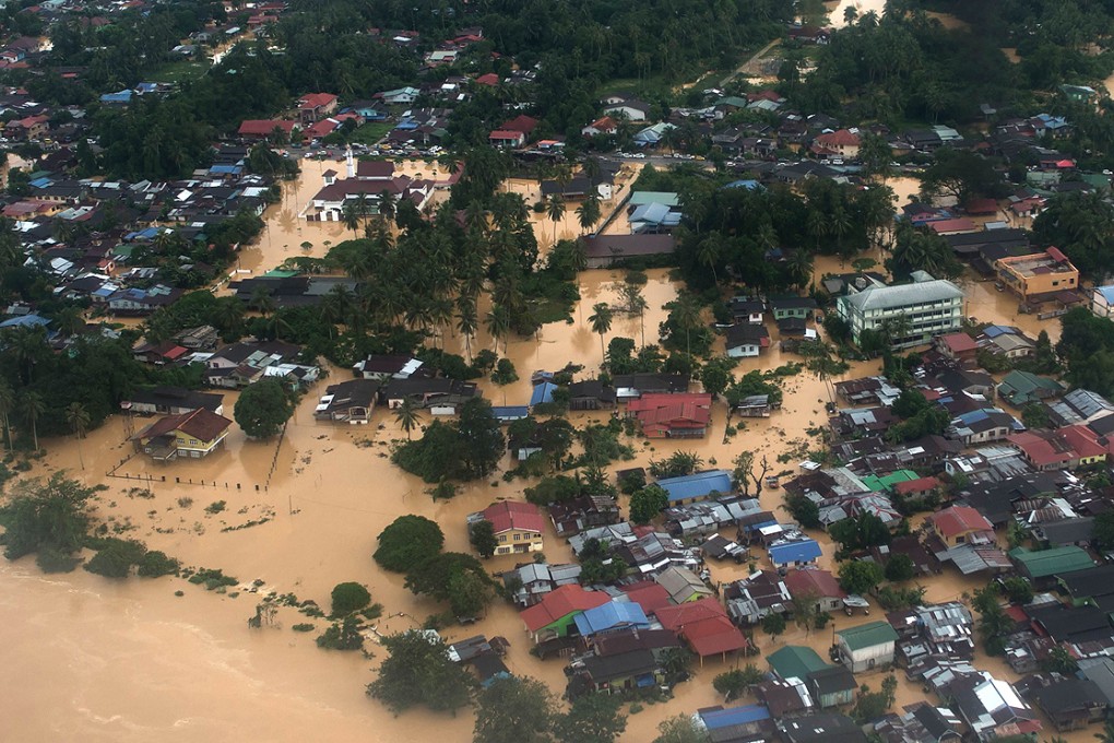 Aerial view shows houses submerged under flood waters in Pengkalan Chepa, near Kota Bharu on Saturday. Photo: AFP