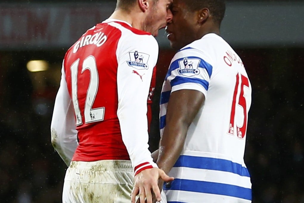 Arsenal's Olivier Giroud head butts Queens Park Rangers' Nedum Onuoha, but the Gunners still triumphed 2-1 at the Emirates Stadium. Photo: Reuters