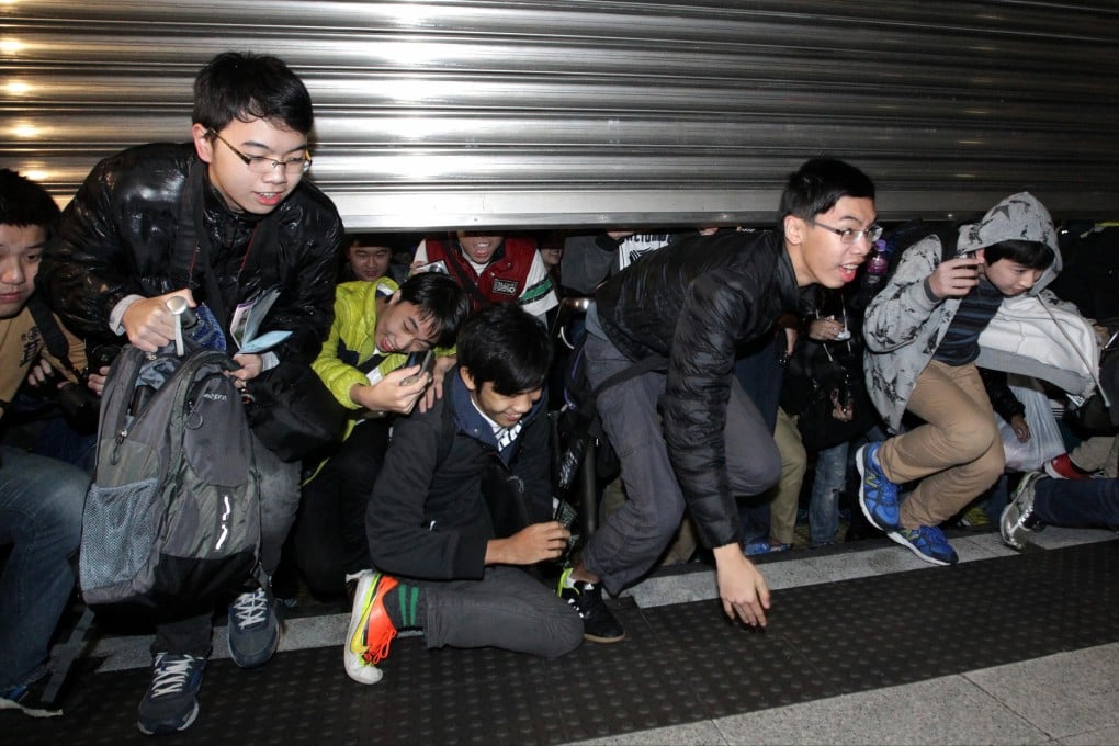 Passengers rush into Kennedy Town MTR station during the opening yesterday of the West Island Line, connecting Sheung Wan to Kennedy Town. Journey times for commuters should be drastically reduced. Photo: Dickson Lee
