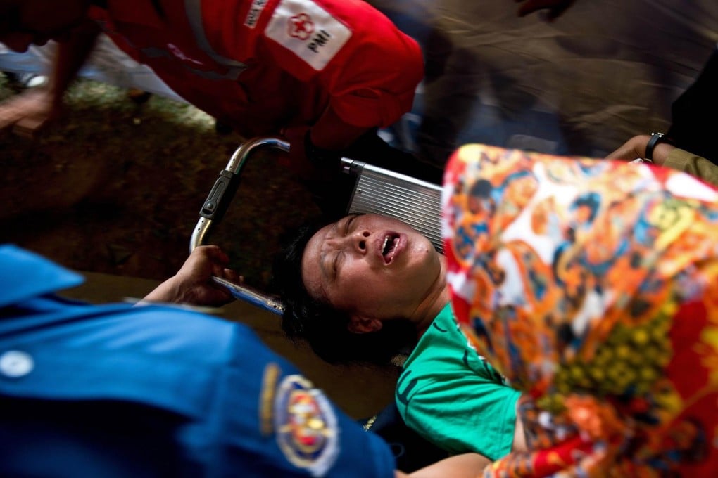 A person receives medical help. Photo: AFP