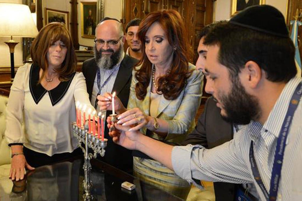 Cristina Fernandez lights a Hanukkah candle. Photo: SCMP