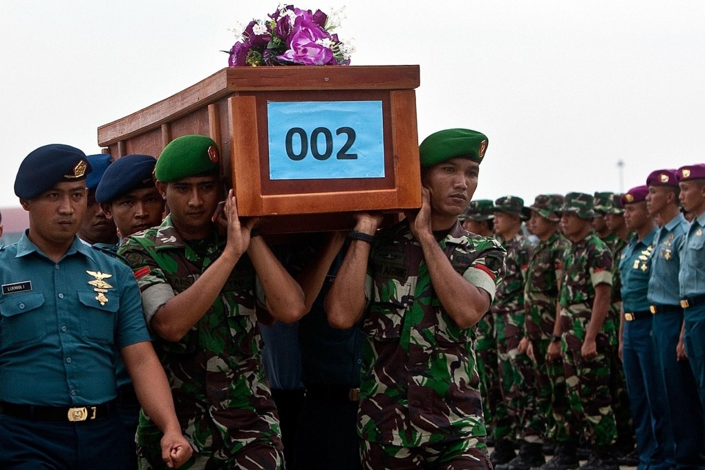 Indonesian military forces carry a victim's coffin. Photo: AFP