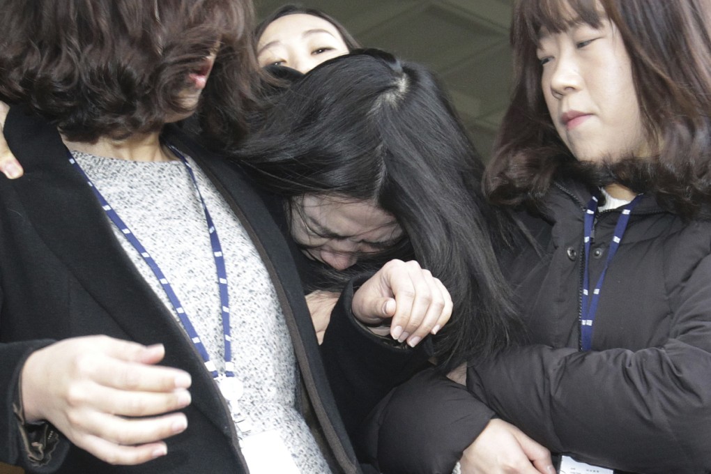 Cho Hyun-ah, center, former vice-president of Korean Air Lines, is escorted by court officials as she leaves for Seoul Western District Prosecutors Office in Seoul on Tuesday. Photo: AP