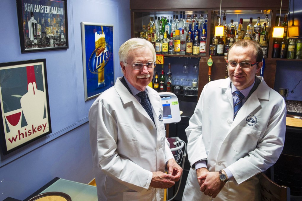 Dr. George Koob (left) and Dr. Lorenzo Leggio pose for a photograph in a research laboratory designed as a bar inside the National Institutes of Health's hospital in Bethesda. Photo: AP