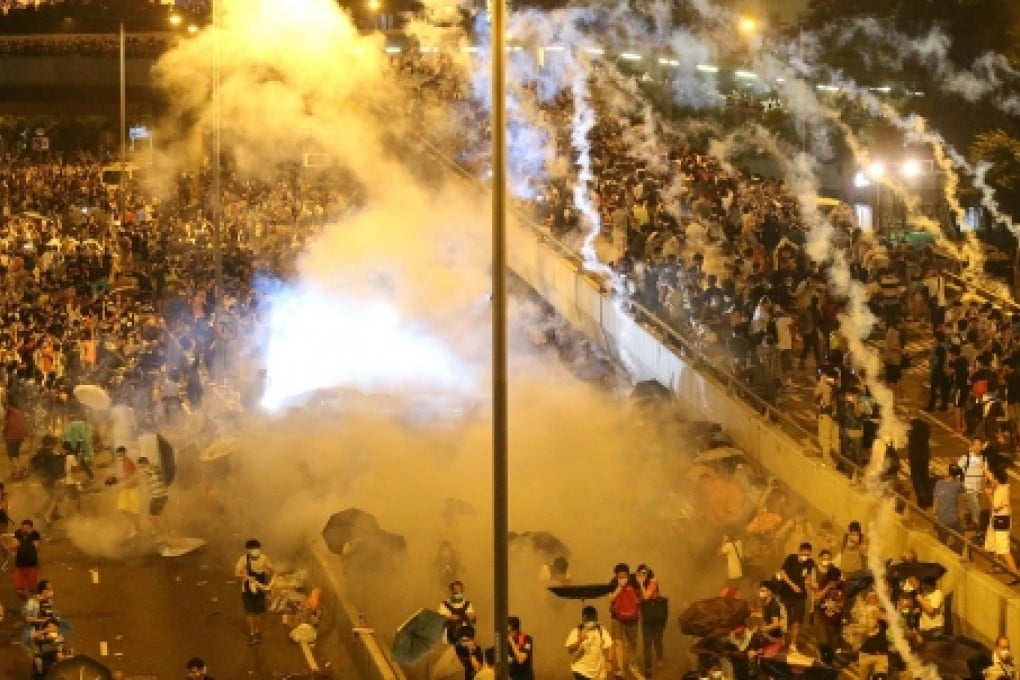 Police in riot gear fire tear gas at Occupy Central protesters in Connaught Road Central, Admiralty. Photo: K.Y. Cheng