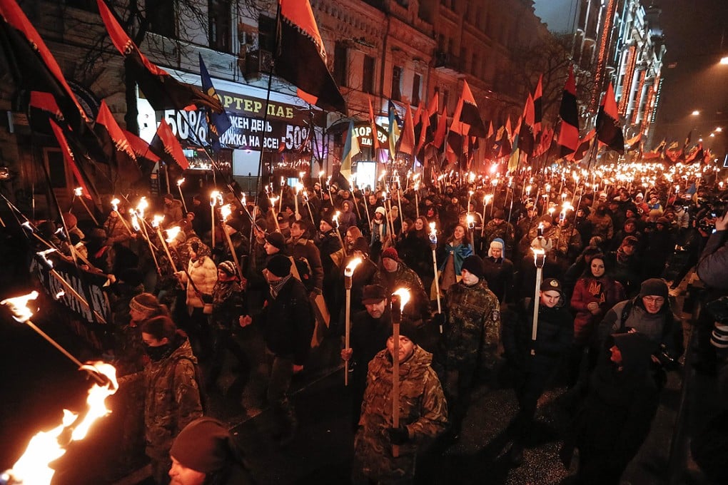 Ukrainian nationalists carry torches during a march to mark the 106th anniversary of right wing world war two resistance fighter Stepan Bandera's birth, in Kiev on Thursday. Photo: EPA
