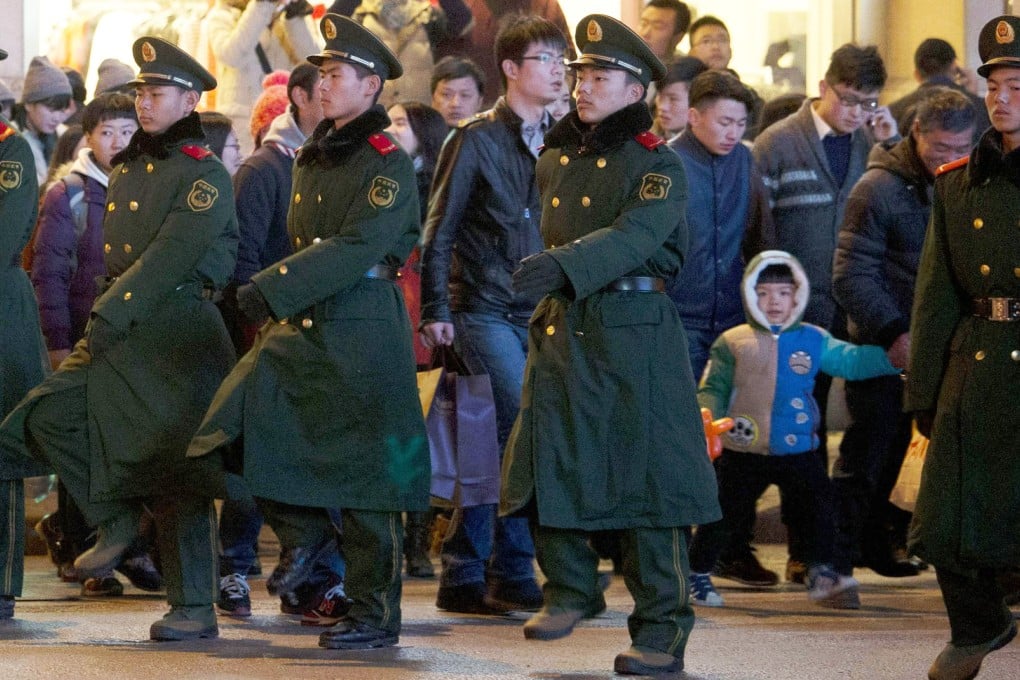 Paramilitary police direct pedestrians yesterday near Chen Yi Square, where the stampede occurred on New Year's Eve. Photo: AP